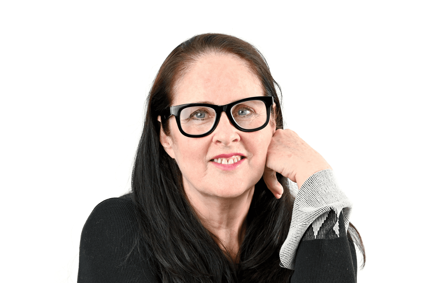 A headshot of Cheryl who sits with one hand on her face, she is wearing dark rimmed glasses and has dark hair