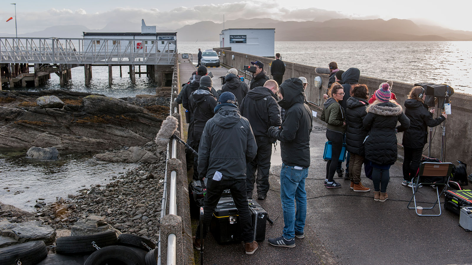 A large amount of crew filming on a pier for Bannan
