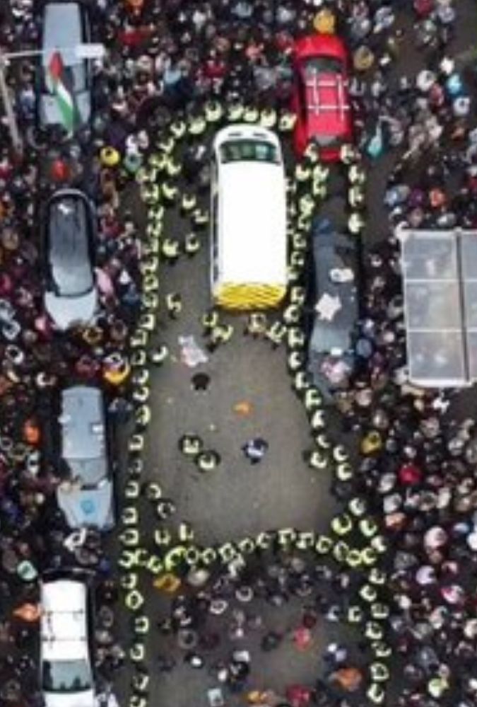 Aerial shot of a street in Glasgow from above, filled with people and vehicles