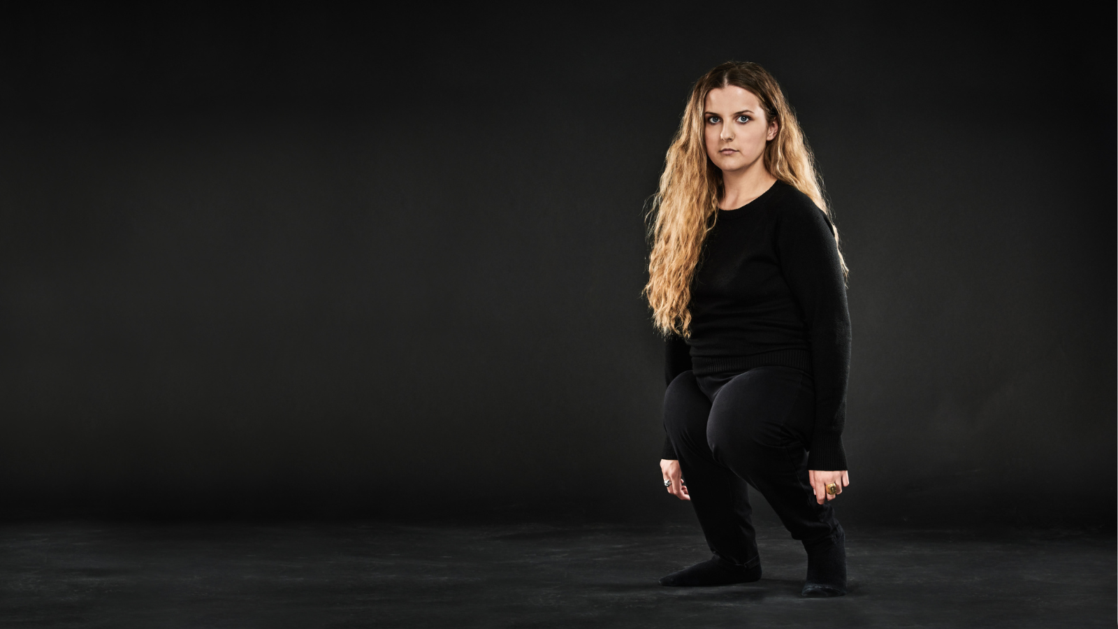 Writer /director Ella Dlendining looking at the camera wearing all black with long blonde hair.