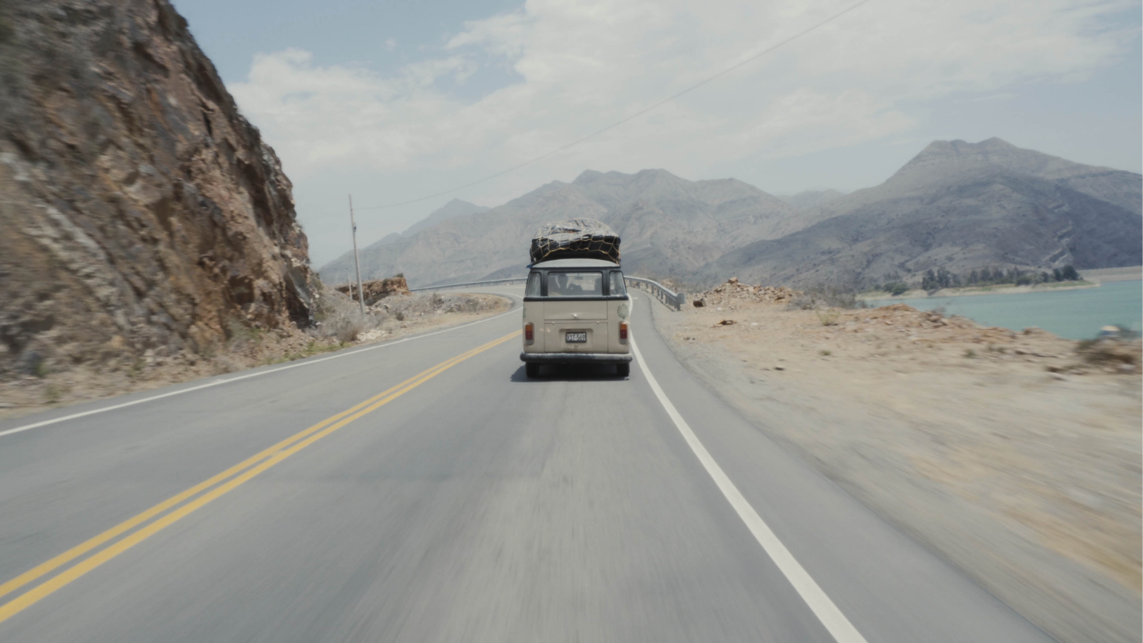 A minibus speeding away on an empty highway