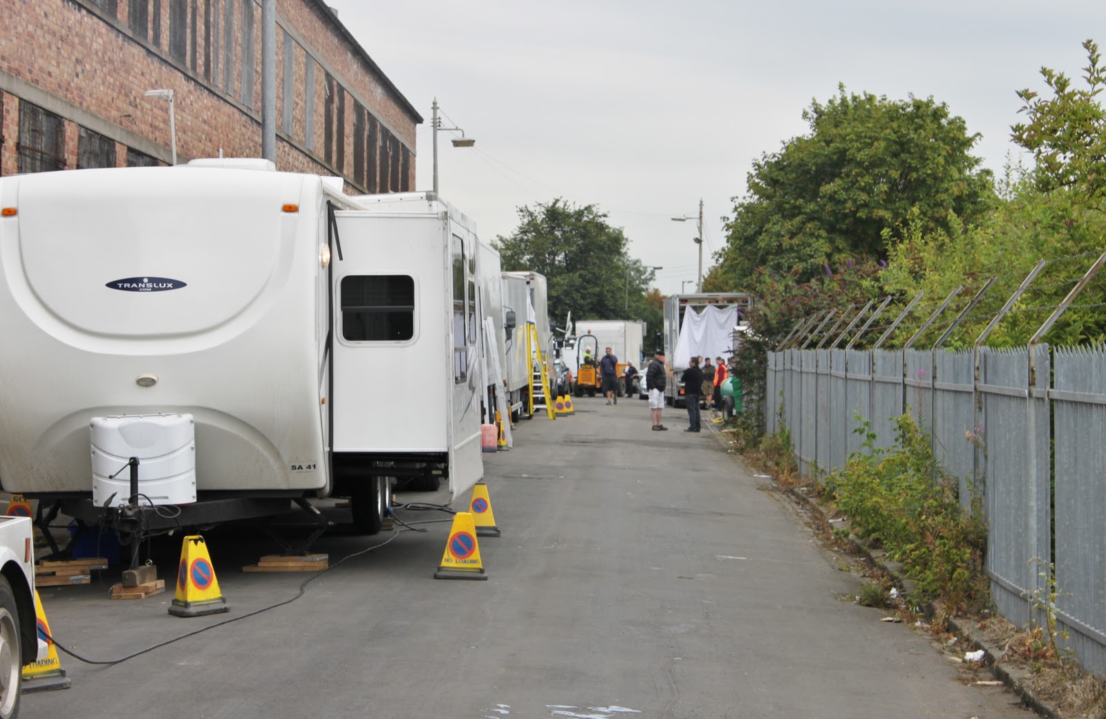 An external image of Govan Shed with production crew and vechicles