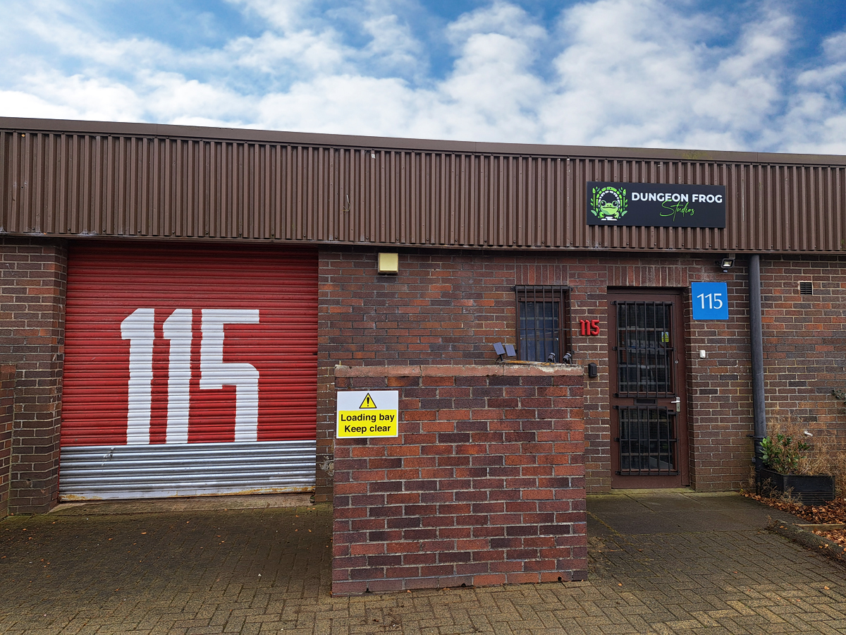 A brick building with a red door
