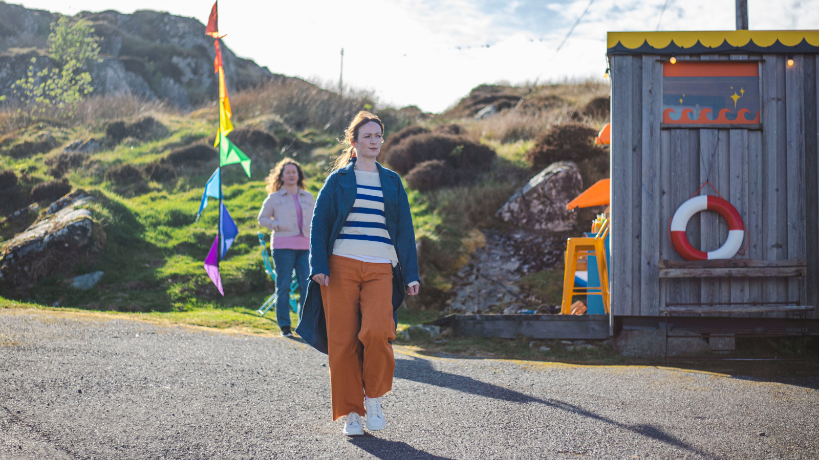 An Clò Mòr still of woman waling along street in the Outer Hebrides