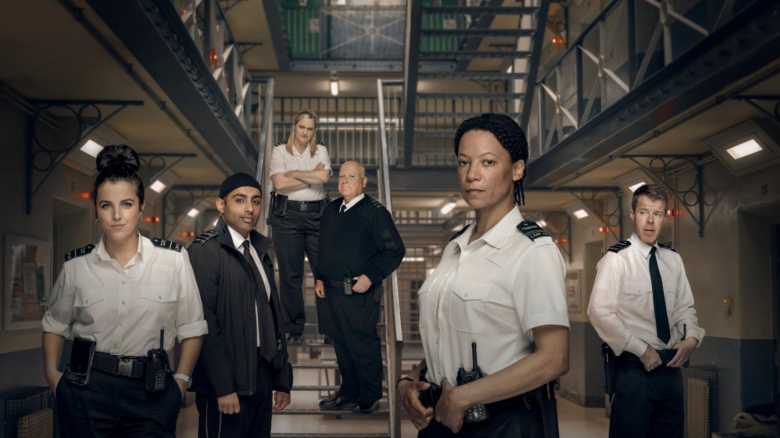 Screw promotional image. Prison officers in prison.