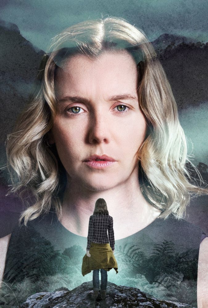 A serene, mountainous landscape with misty skies forms the backdrop for a pensive woman with wavy blonde hair, wearing a black top. Overlaying her image is a silhouette of a person standing on a rocky ridge, facing the distant mountains.