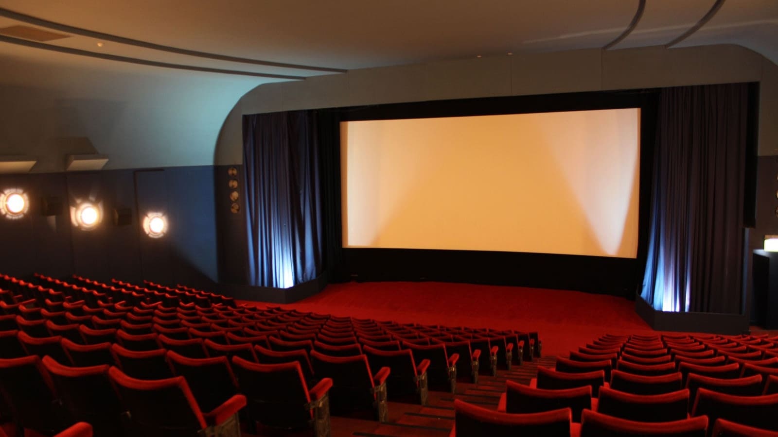 Interior of a cinema with red seats