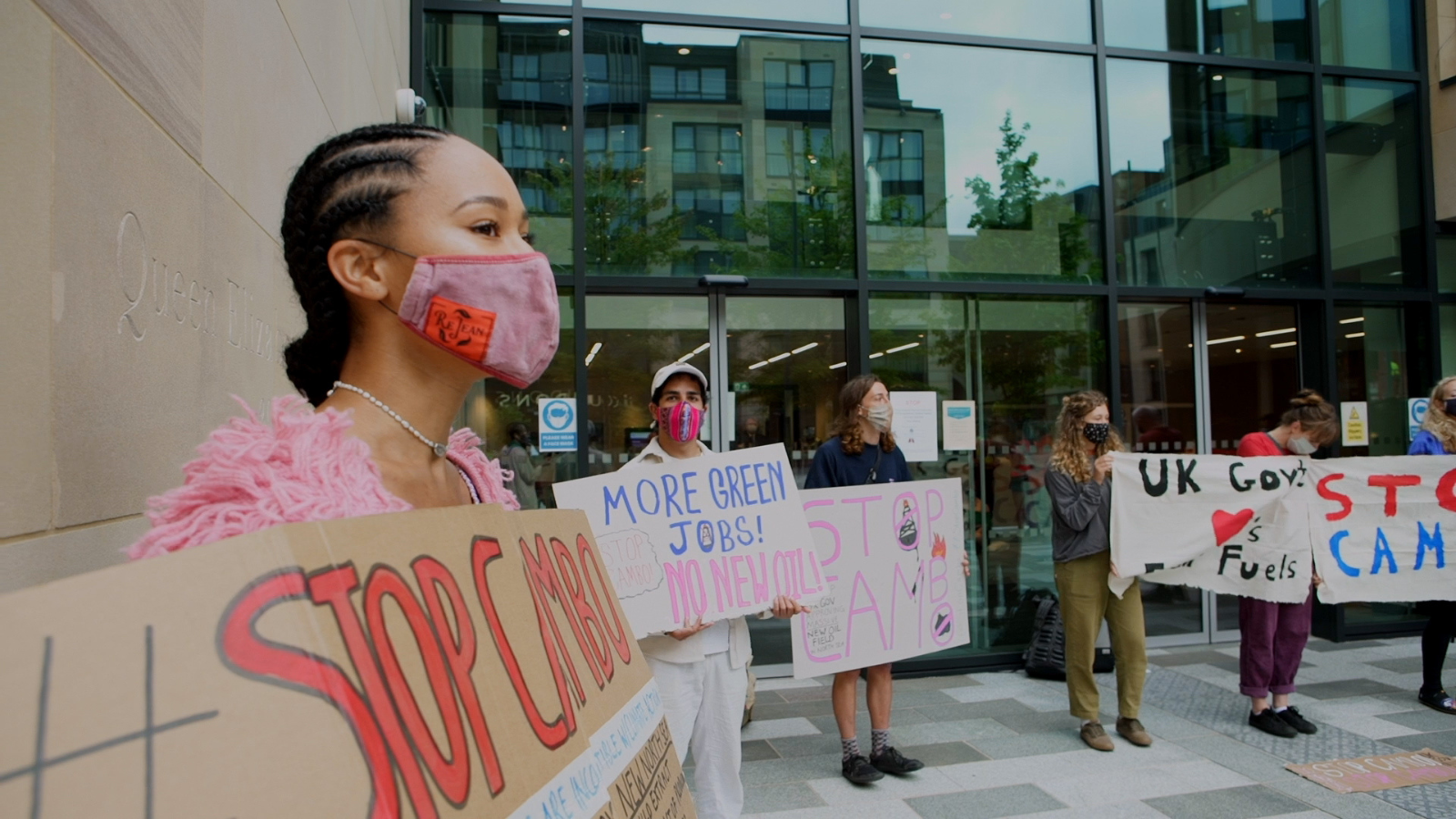 Still of campaigners from The Oil Machine