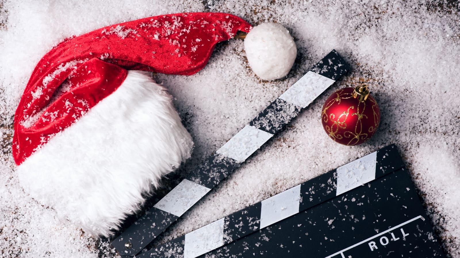 A clapperboard next to a Christmas santa hat