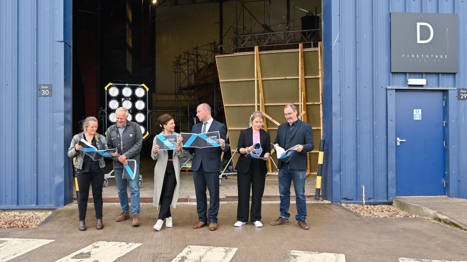 Key stakeholders standing outside first stage studios for the publication of the Economic Impact Report 2021