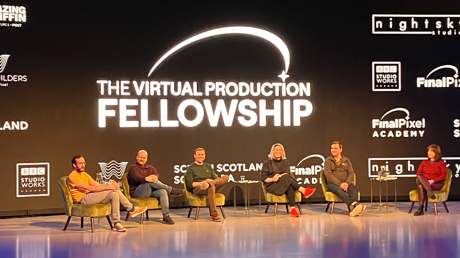 A row of people sit on stage in front of a huge screen used for virtual production at the Final Pixel launch event