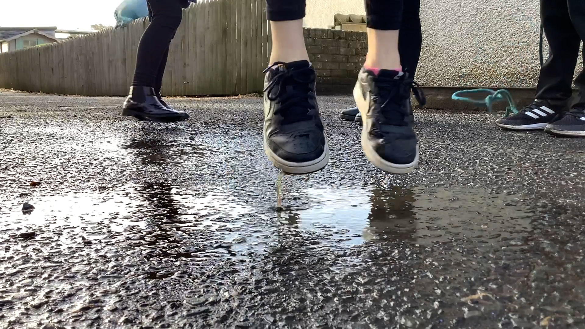 till from Seven x Seven, courtesy of Alchemy. A close up of feet in carpark jumping off the ground.