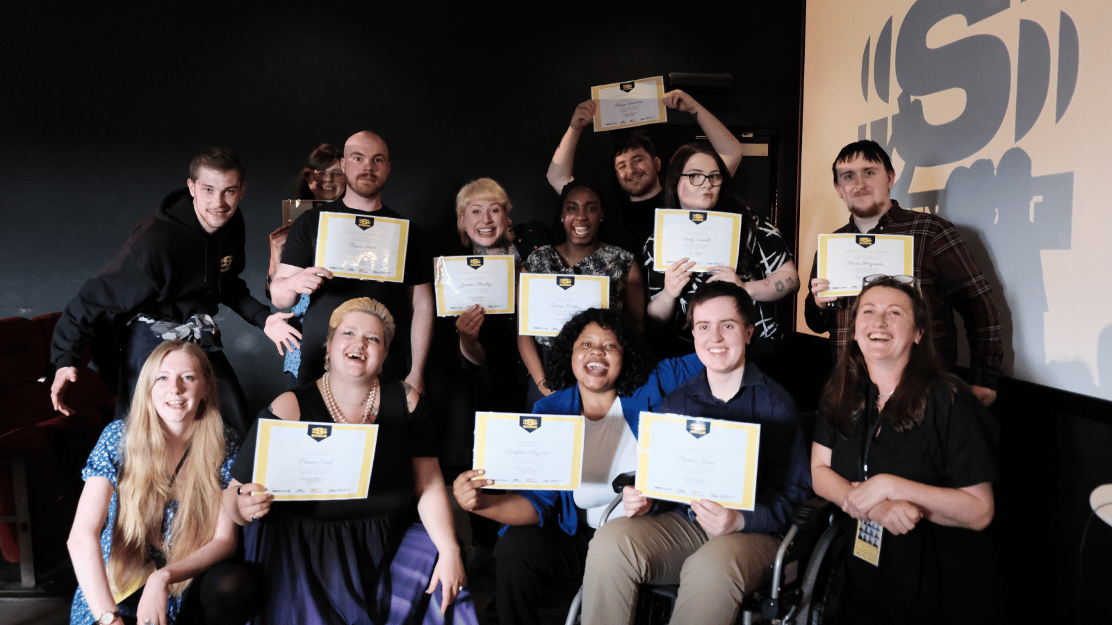 GMAC's Screen Start graduates posting in a group with their course completion certificates in hand.