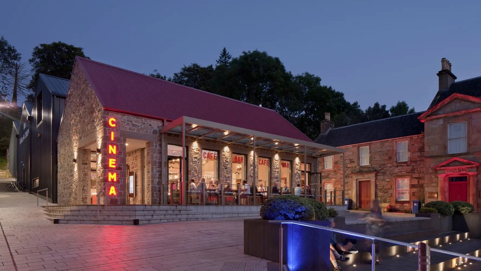 A stone building with a red roof labeled 