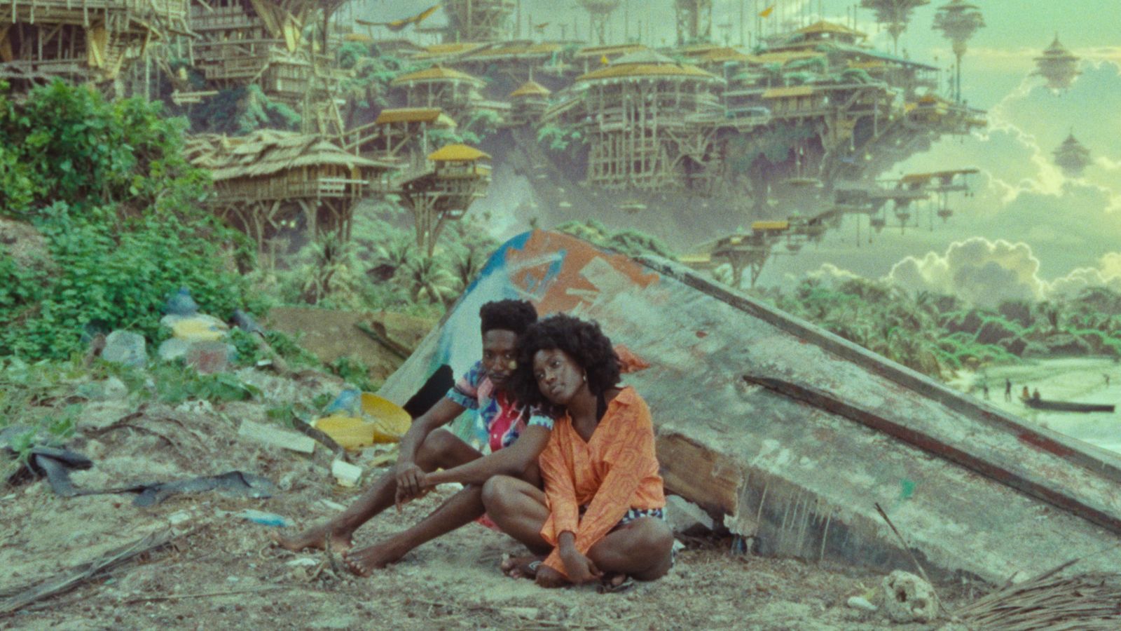 Two people sit on a sandy beach, leaning against a large piece of debris with colourful graffiti. They are surrounded by scattered litter. In the background, a futuristic city floats above lush greenery and clouds, featuring intricate wooden structures and suspended platforms.