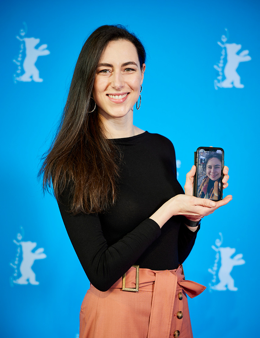 Charlotte at Berlinale with Director Laura on FaceTime on her phone.