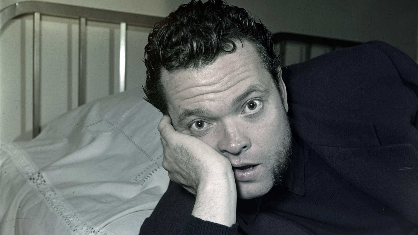 Orson Welles Headshot - Orson Welles leans on his face