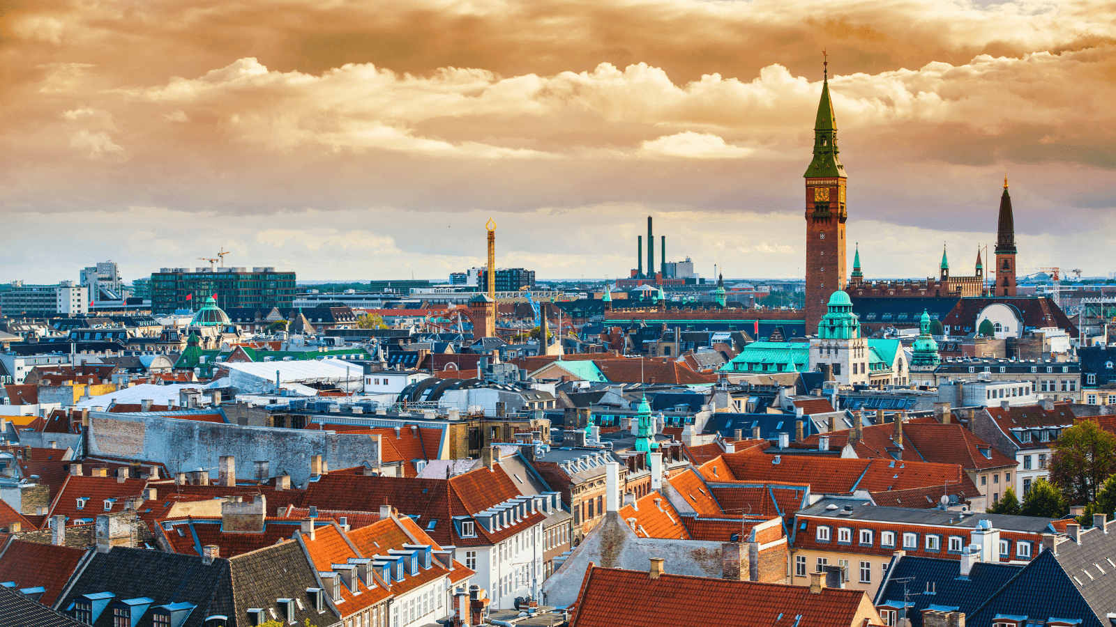 A cityscape looking over Copenhagen with a golden sky