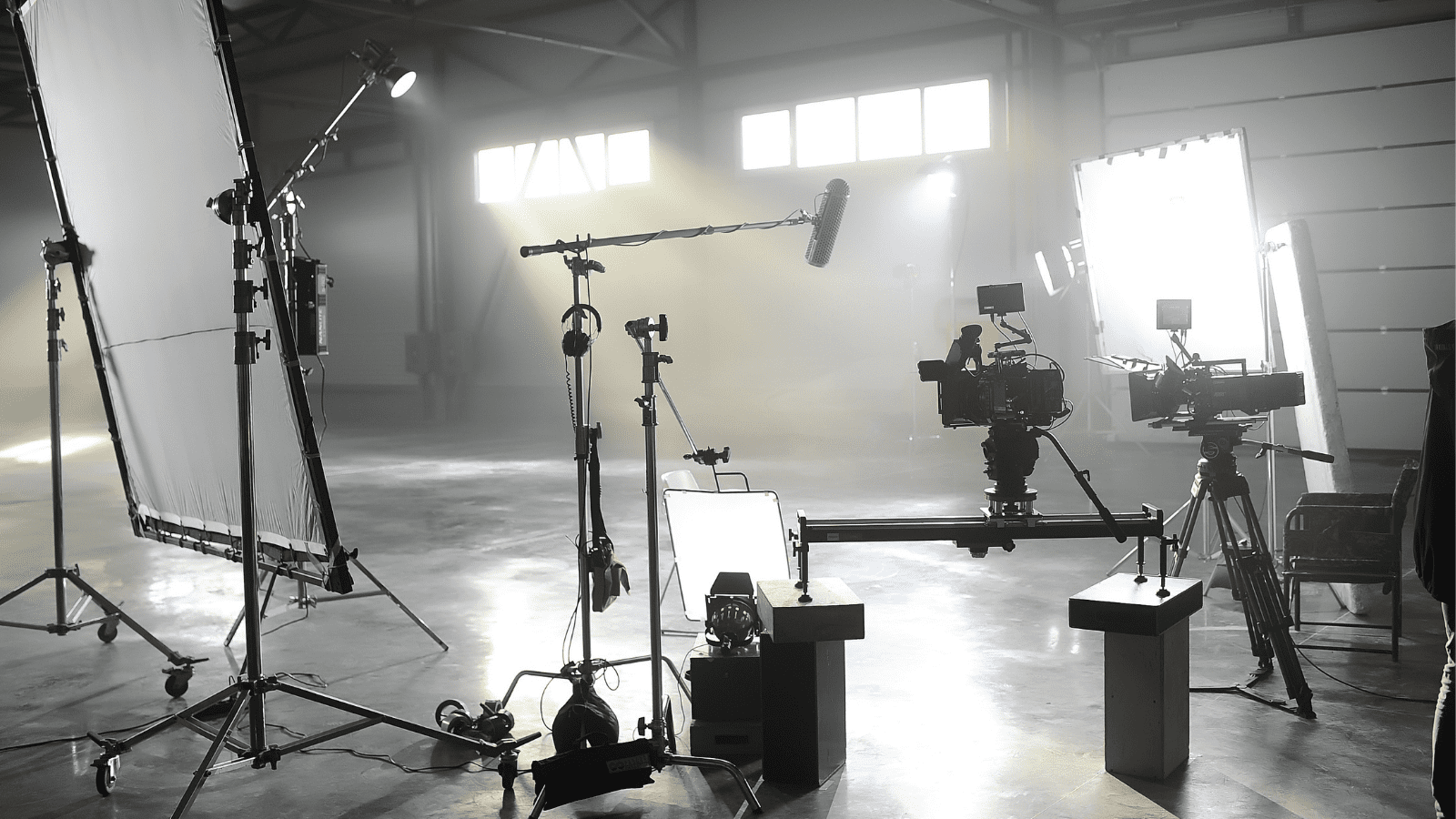 Behind the scenes in a light filled studio with lots of camera equipment