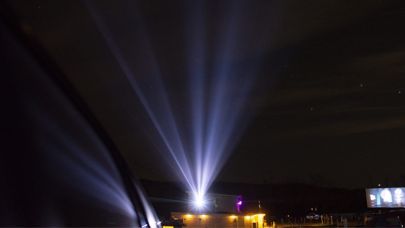 A cinema projector outdoors at night